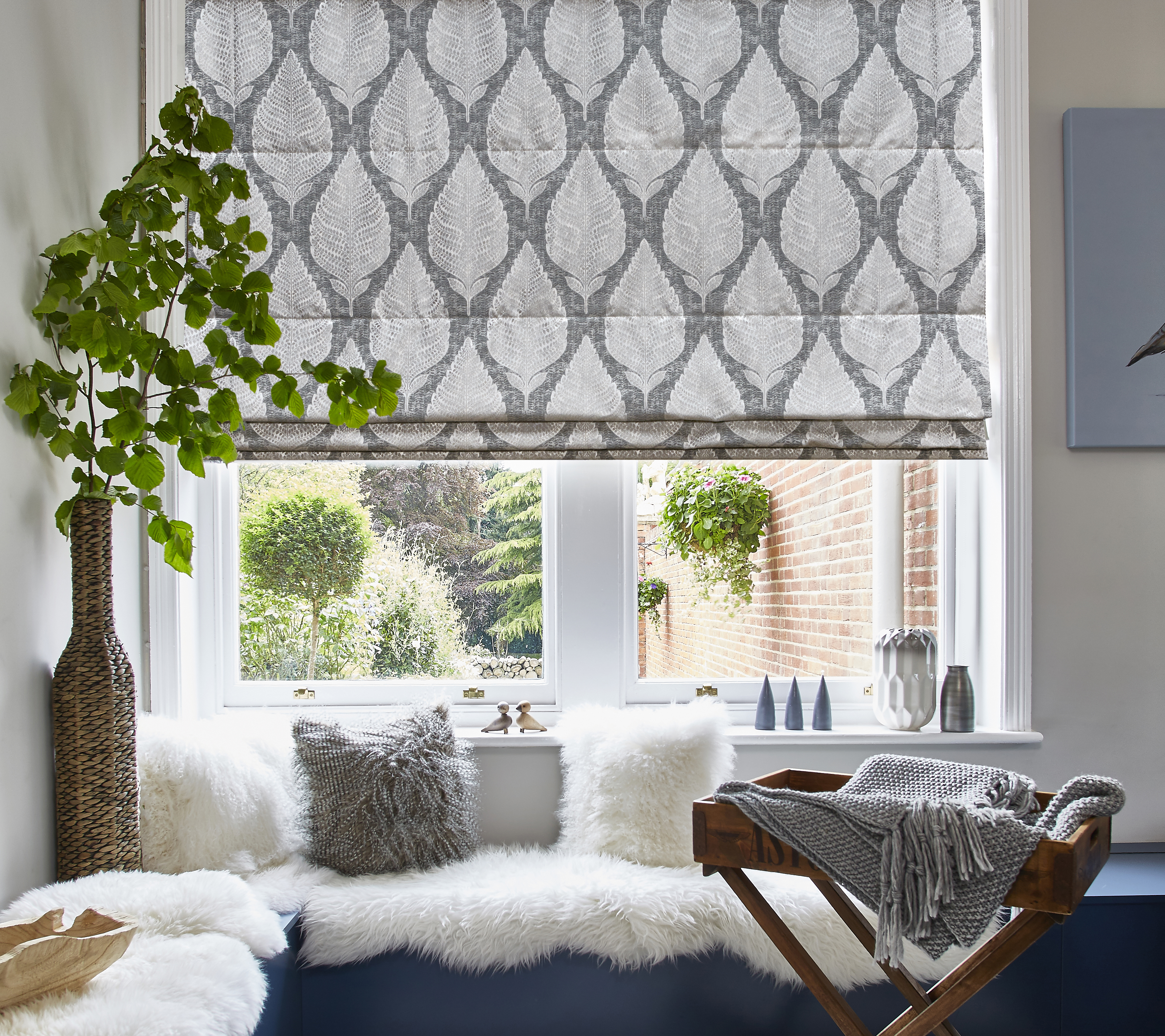 portrait stylish Roman blinds in a bright kitchen window