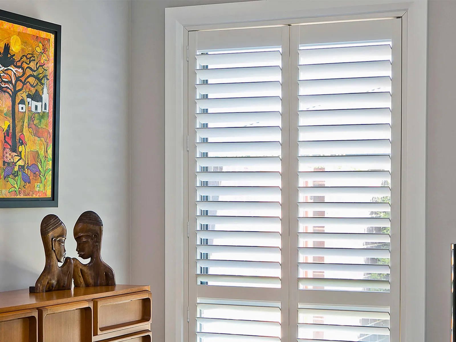 portrait elegant white plantation shutters in a sunlit room